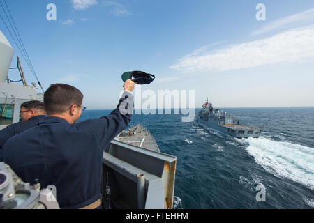 BLACK SEA (Oct. 16, 2014) – Cmdr. James Quaresimo aboard the Arleigh Burke-class guided-missile destroyer USS Cole (DDG 67) waves good-bye to the Turkish navy Barbaros-class frigate TCG Salihreis (F 246) during a passing exercise. Cole, homeported in Norfolk, Va., is conducting naval operations in the U.S. 6th Fleet area of operations in support of U.S. national security interests in Europe. Stock Photo