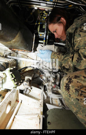 SIGONELLA, Sicily (Oct. 28, 2014) - Aviation Structural Mechanic 3rd Class Nicole Bitzer assigned to Patrol Squadron FOUR (VP 4) wipes excess hydraulic fluid from the inside of the hydraulic service center of the P-3C Orion maritime patrol aircraft. VP 4 is conducting naval operations in the U.S. 6th Fleet area of operations in support of U.S. national security interests in Europe. Stock Photo