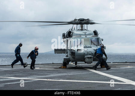 MEDITERRANEAN SEA (Oct. 29, 2014) – Flight deck crew prepare an MH-60S Sea Hawk helicopter assigned to the Ghostriders of Helicopter Sea Combat Squadron (HSC 28), Detachment 1, aboard the U.S. 6th fleet command and control ship USS Whitney (LCC 20) for lift off. Mount Whitney is conducting naval operations with allies and partners in the U.S. 6th Fleet area of operations in order to advance security and stability in Europe. Stock Photo