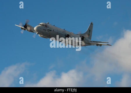 MEDITERRANEAN SEA (Nov. 15, 2014) – A U.S. Navy P-3C Orion maritime patrol aircraft attached to the ‘Skinny Dragons’ of Patrol Squadron FOUR (VP 4) conducts a fly by with USS Cole (DDG 67). Cole, an Arleigh Burke-class guided-missile destroyer homeported in Norfolk, is conducting naval operations in the U.S. 6th Fleet area of operations in support of U.S. national security interests in Europe. Stock Photo