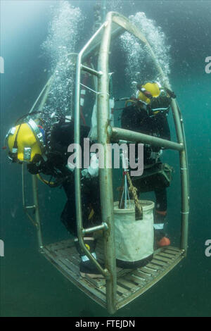 TRIESTE, Italy (Aug. 31, 2015) Navy Diver 2nd Class Octavio Alvarez, left, watches for the sea floor as he and Navy Diver 3rd Class James Lindley descend to conduct excavation of a U.S. aircraft crash site in support of an ongoing Defense Personnel Accounting Agency (DPAA) mission in the northern Adriatic Sea Aug. 31, 2015. Divers from Mobile Diving Salvage Unit 2 and Civilian Mariners from the Military Sealift Command rescue and salvage ship USNS Grasp (T-ARS 51), assigned to Commander, Task Force 68, are currently supporting DPAA for the recovery of U.S. Airmen who have be Stock Photo