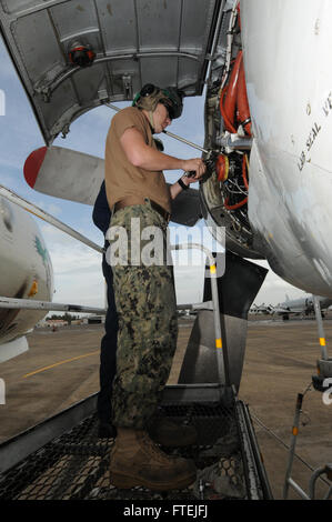 SIGONELLA, Sicily (Dec. 3, 2014) Aviation Machinist’s Mate Airman Brandon Marchant installs safety wires onto a P-3C Orion maritime patrol aircraft belonging to Patrol Squadron (VP) 4, Dec. 3, 2014. VP 4 is conducting naval operations in the U.S. 6th Fleet area of operations in support of U.S. national security interests in Europe. Stock Photo