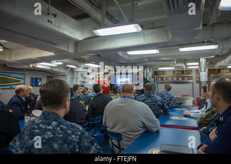 SOUDA BAY, Greece (Dec. 3, 2014) – Cmdr. Dennis Farrell, commanding officer, USS Cole (DDG 67), gives an introduction of the ship to participants of the multinational maritime exercise, Phoenix Express 2015, aboard Cole. Cole, an Arleigh Burke-class guided-missile destroyer, homeported in Norfolk, is conducting naval operations in the U.S. 6th Fleet area of operations in support of U.S. national security interests in Europe. Stock Photo