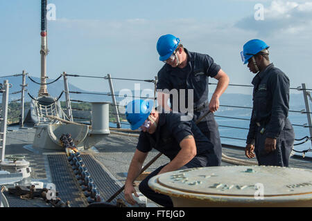 SOUDA BAY, Greece (Dec. 4, 2014) Sailors aboard USS Cole (DDG 67) release the pelican hook on the centerline anchor chain as the ship departs Souda Bay following a scheduled port visit, Dec. 4, 2014. Cole, an Arleigh Burke-class guided-missile destroyer, homeported in Norfolk, is conducting naval operations in the U.S. 6th Fleet area of operations in support of U.S. national security interests in Europe. Stock Photo