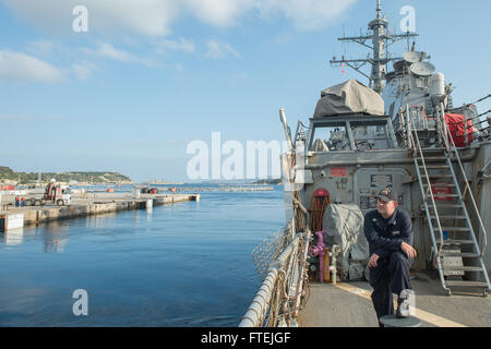 SOUDA BAY, Greece (Dec. 4, 2014) A Sailor aboard USS Cole (DDG 67) watches as the ship departs Souda Bay after a scheduled port visit, Dec. 4, 2014. Cole, an Arleigh Burke-class guided-missile destroyer, homeported in Norfolk, is conducting naval operations in the U.S. 6th Fleet area of operations in support of U.S. national security interests in Europe. Stock Photo