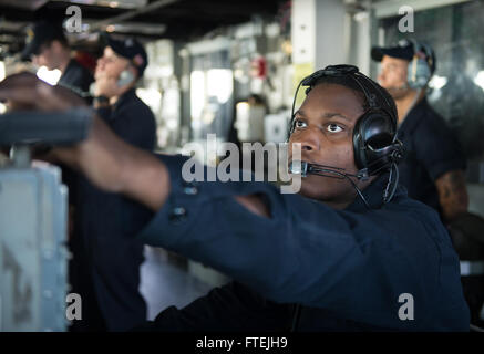 Operations Specialist 2nd Class Ryan Barnett stands watch during a