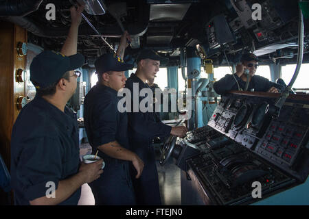 MEDITERRANEAN SEA (Dec. 20, 2014) – Aviation Boatswain’s Mate (Handling) Airman William Terry, center-left, from Hope Mills, North Carolina, engages the ship’s horn aboard USS Cole (DDG 67) as the ship goes full-astern during a torpedo evasion maneuvers exercise, Dec. 20, 2014. Cole, an Arleigh Burke-class guided-missile destroyer, homeported in Norfolk, is conducting naval operations in the U.S. 6th Fleet area of operations in support of U.S. national security interests in Europe. Stock Photo