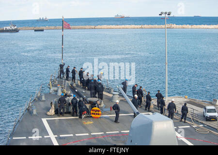 HAIFA, Israel (Dec. 23, 2014) Sailors aboard USS Cole (DDG 67) raise the First Navy Jack as the ship moors pierside in Haifa, Israel for a scheduled port visit, Dec. 23, 2014. Cole, an Arleigh Burke-class guided-missile destroyer, homeported in Norfolk, is conducting naval operations in the U.S. 6th Fleet area of operations in support of U.S. national security interests in Europe. Stock Photo