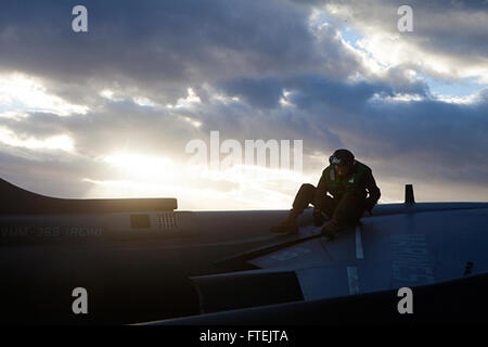 MEDITERRANEAN SEA (Dec. 28, 2014) Lance Cpl. Daniel Vanwyhe, an aircraft electrical systems technician with Marine Medium Tiltrotor Squadron 365 (Reinforced), 24th Marine Expeditionary Unit (MEU), conducts routine maintenance on an AV-8B Harrier II aboard USS Iwo Jima (LHD 7) Dec. 28, 2014. The 24th MEU and Iwo Jima Amphibious Ready Group are conducting naval operations in the U.S. 6th Fleet area of operations in support of U.S. national security interests in Europe. Stock Photo