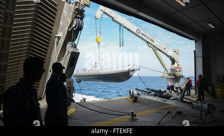 ATLANTIC OCEAN (Jan. 24, 2015) U.S. Navy Sailors and Military Sealift Command civil service mariners work together to conduct small boat operations aboard the Military Sealift Command’s joint high-speed vessel USNS Spearhead (JHSV 1), Jan 24, 2015. Spearhead is on a scheduled deployment to the U.S. 6th Fleet area of operations in support of the international collaborative capacity-building program Africa Partnership Station. Stock Photo