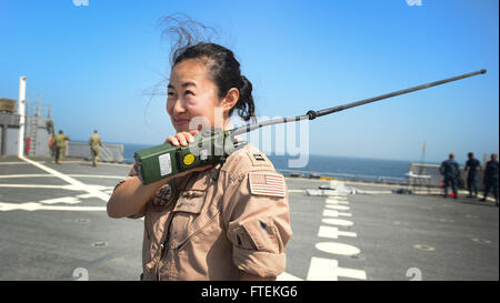 150126-N-RB579-105 ATLANTIC OCEAN (Jan. 26, 2015) Lt. Cecilia Hu, from Los Angeles, coordinates a fly-over with the crew of a P-3 Orion aircraft, while aboard the Military Sealift Command’s joint high-speed vessel USNS Spearhead (JHSV 1) Jan 26, 2015. Spearhead is on a scheduled deployment to the U.S. 6th Fleet area of operations in support of the international collaborative capacity-building program Africa Partnership Station. (U.S. Navy photo by Mass Communication Specialist 1st Class Joshua Davies/Released) Stock Photo