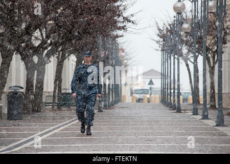 NAPLES, Italy (Feb. 9, 2015) Senior Chief Mass Communication Specialist Daniel Sanford, originally from Buffalo, New York, strides through a snowstorm at Naval Support Activity Naples, Feb. 9, 2015. NSA Naples, home to U.S. Naval Forces Europe-Africa/U.S. 6th Fleet headquarters, is located on the southwest coast of Italy, and does not typically receive much snowfall. (U.S. Navy photo by Mass Communication Specialist 3rd Class Daniel P. Schumacher/Released) Stock Photo