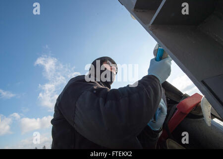 Seaman Apprentice Matthew Sharley performs preventative maintenance on USS Cole (DDG 67) while the Arleigh Burke-class destroyer conducts operations in the U.S. 6th Fleet. Based in Norfolk, the USS Cole plays a vital role in supporting U.S. national security interests in Europe. Stock Photo