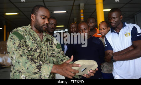 ATLANTIC OCEAN (Feb. 13, 2015) Chief Operations Specialist Dwayne Brown, from New York City, discusses the capabilities of the RQ-20A Aqua Puma small unmanned aircraft with embarked Ghanaian military personnel aboard the Military Sealift Command's joint high-speed vessel USNS Spearhead (JHSV 1) Feb. 13, 2015. Spearhead is on a scheduled deployment to the U.S. 6th Fleet area of operations in support of the international collaborative capacity-building program Africa Partnership Station. (U.S. Navy photo by Mass Communication Specialist 1st Class Joshua Davies/Released) Stock Photo