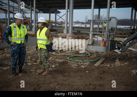 Romania (Feb. 19, 2015) Commander, Naval Facilities Engineering Command Chief of Civil Engineers Rear Adm. Katherine L. Gregory follows Naval Support Facility (NSF) Deveselu Executive Officer Cmdr. Rod Tribble during a tour of the ongoing construction of permanent facilities at NSF Deveselu Feb. 19, 2015. NSF Deveselu is Navy Region Europe Africa Southwest Asia’s latest tool for providing efficient and effective shore service support to United States and Allied Forces operating in Europe, Africa and Southwest Asia. Gregory’s visit included a tour of the temporary f Stock Photo