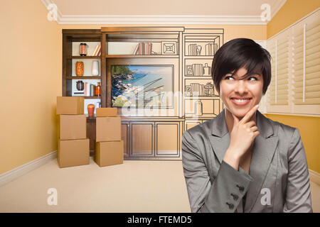 Young Mixed Race Female Looking To The Side In Room With Drawing of Entertainment Unit On Wall. Stock Photo