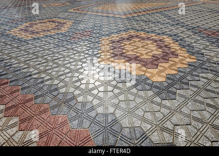 Flooring in geometric patterns made with concrete paving blocks and tiles Stock Photo