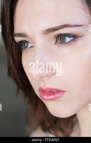 Serious young woman looking away Stock Photo