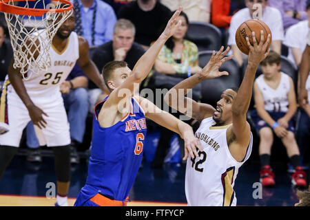 New Orleans, LA, USA. 28th Mar, 2016. New Orleans Pelicans center Alexis Ajinca (42) shoots against New York Knicks forward Kristaps Porzingis (6) during an NBA basketball game between the New York Knicks and the New Orleans Pelicans at the Smoothie King Center in New Orleans, LA. Stephen Lew/CSM/Alamy Live News Stock Photo