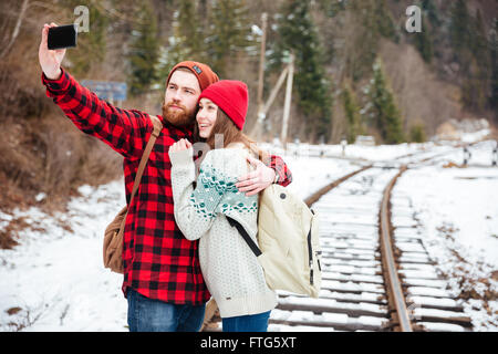 Happy couple making selfie photo on railway Stock Photo