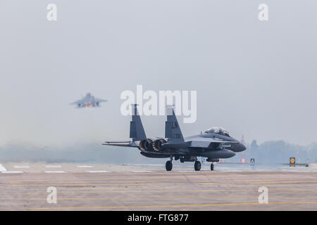 An F-15E Strike Eagle follows its colleague into the sky at RAF Lakenheath Stock Photo