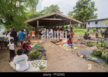 Seghe, Solomon Islands - June 16, 2015: People buying and selling food at the local market in the village of Seghe. Stock Photo