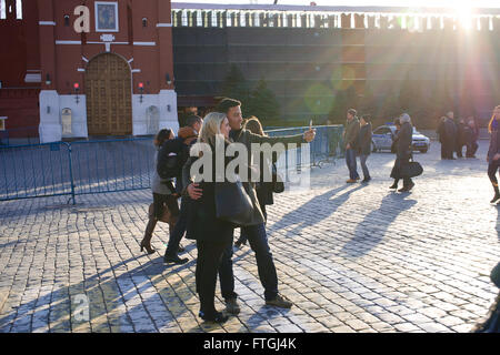 03/26/2016 Russia, Moscow. A series of 'Walking in Moscow. Moscow and faces.' Red Square. Tourists make selfie in front of St. B Stock Photo