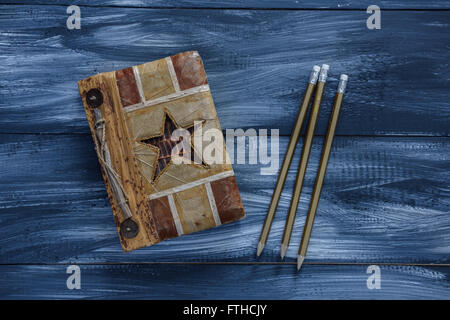 Notebook and pencil on wooden background Stock Photo