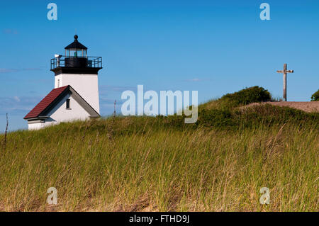 Long Point Light can be found a few miles from Provincetown, at the tip of Cape Cod. There is a cross memorial on a hill nearby. Stock Photo