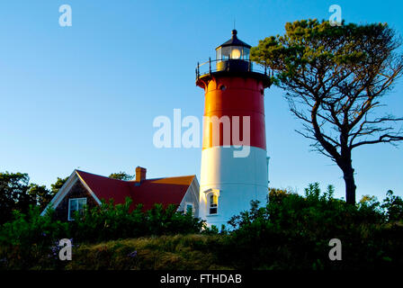 Nauset Lighthouse lantern shines brightly at dusk on a summer evening on Cape Cod, Massachusetts. Stock Photo