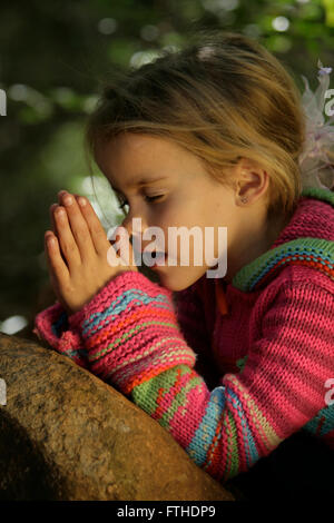 Little girl praying Stock Photo