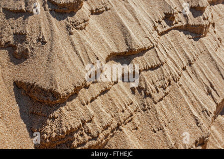 Closeup of textures and patterns in beach sand caused by wind erosion Stock Photo