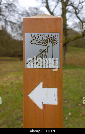 Wooden marker post on the Bishop's Path in the Deer Park at Auckland Castle showing a Knight with a lance Stock Photo