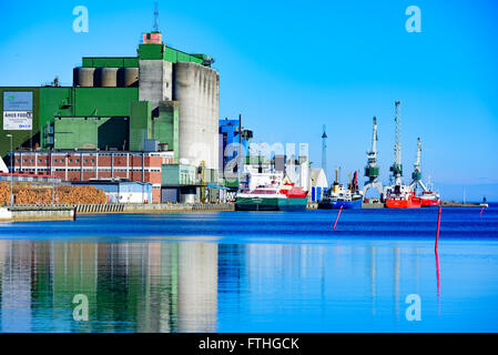 Ahus, Sweden - March 20, 2016: The harbor in Ahus is one of Southern Swedens most important bulk ports. Here seen from the canal Stock Photo