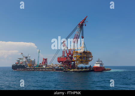 Oil rig lifting for installation on its jacket Stock Photo