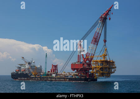 Oil rig lifting for installation on its jacket Stock Photo