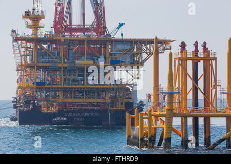 Oil rig lifting for installation on its jacket Stock Photo