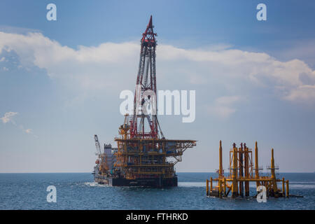 Oil rig lifting for installation on its jacket Stock Photo