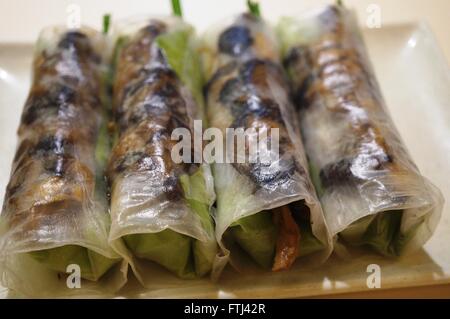 Vegetarian Vietnamese summer rolls with translucent rice paper, salad, and mushroom Stock Photo