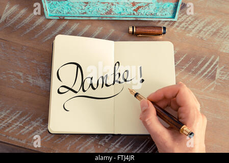 Handwritten text in German 'Danke'  - translation : Thank You as business concept image Stock Photo