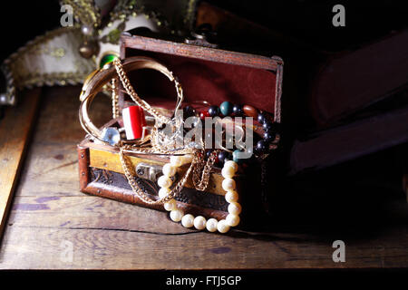 Closeup of open jewelry box on wooden background Stock Photo