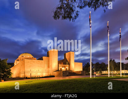 Australian national war memorial in Canberra at sunrise with bright illumination under blurred cloudy sky with nobody at dawn. Stock Photo