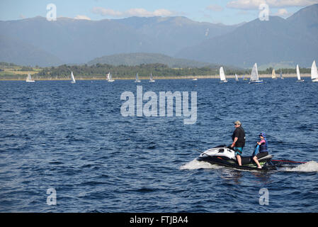 MOANA, NEW ZEALAND, FEBRUARY 6, 2016: Jet ski and sail boats on Lake Brunner, February 6, 2016, New Zealand Stock Photo