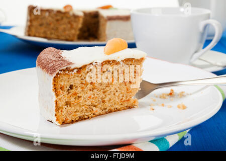 Piece of Carrot cake on a plate, on coffee table Stock Photo