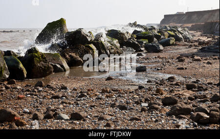 Waves crashing over Sea Defences at Happisburgh in Norfolk England UK Stock Photo