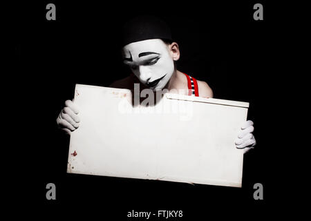 Portrait of mime holding white dirty sheet in hands Stock Photo