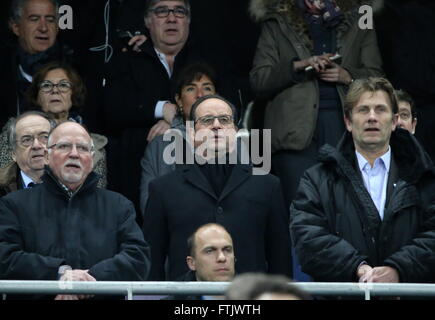 Paris, France. 29th Mar, 2016. France's President Francois Hollande (C) listening to the French national anthem ahead of a friendly football match between France and Russia at the Stade de France. Credit:  Alexander Demianchuk/TASS/Alamy Live News