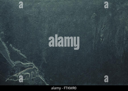 Vintage toned grunge background or texture made of cracked dark slate. Stock Photo