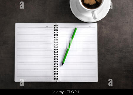 Notebook with pen and cup of coffee. Top view of writer's workplace Stock Photo