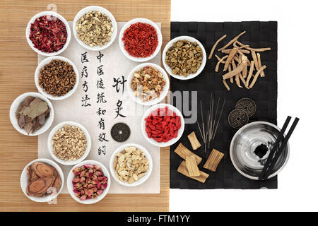 Chinese herbs, acupuncture needles, moxa sticks and i ching coins with calligraphy on rice paper. Translation describes acupunct Stock Photo